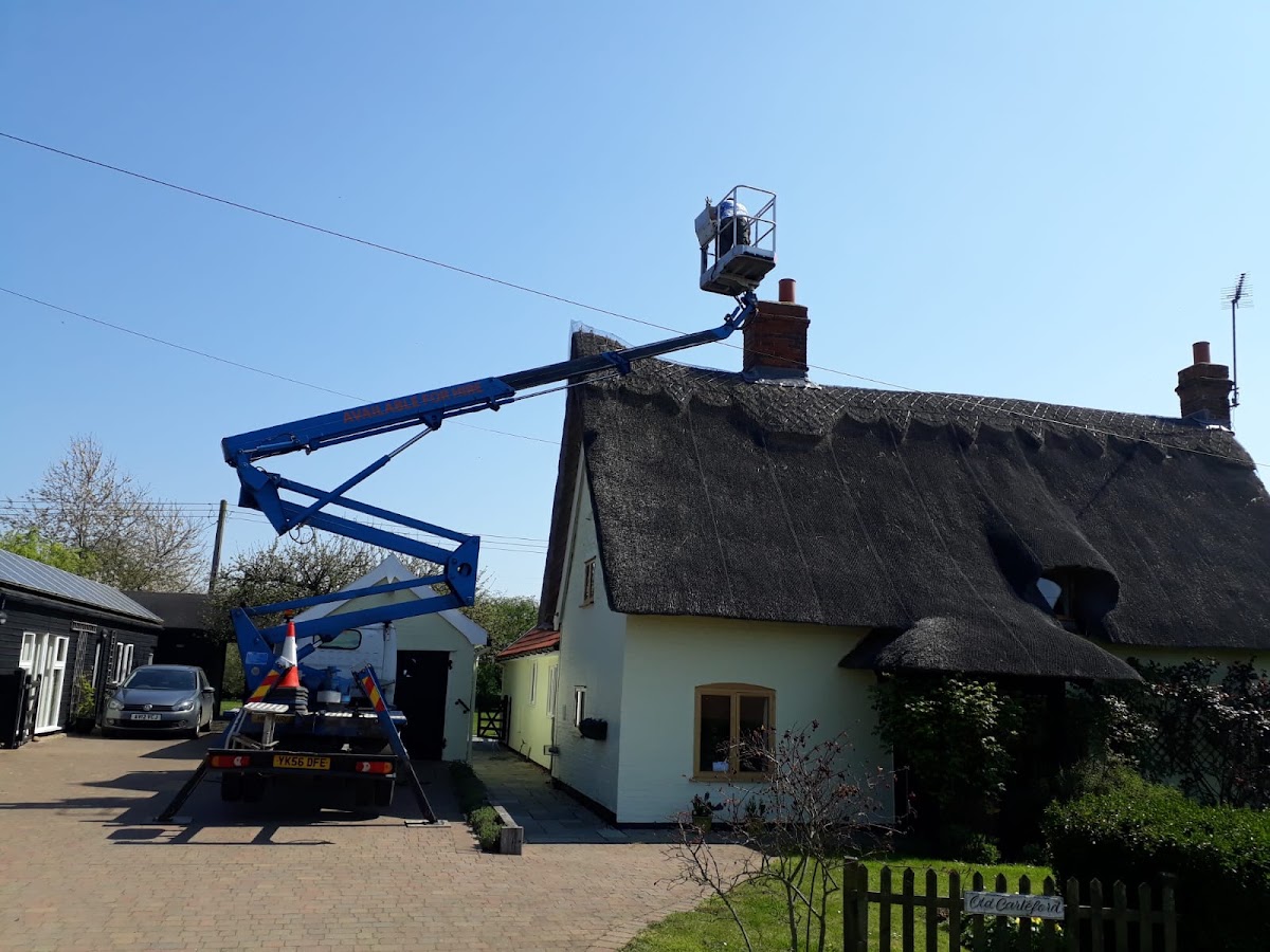 Access platform reaching the chimney of a thatched Suffolk cottage